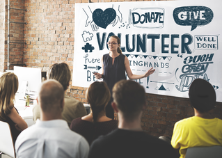 woman presenting in front of people